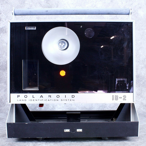 Three photographs of the Polaroid ID-2 at different angles.