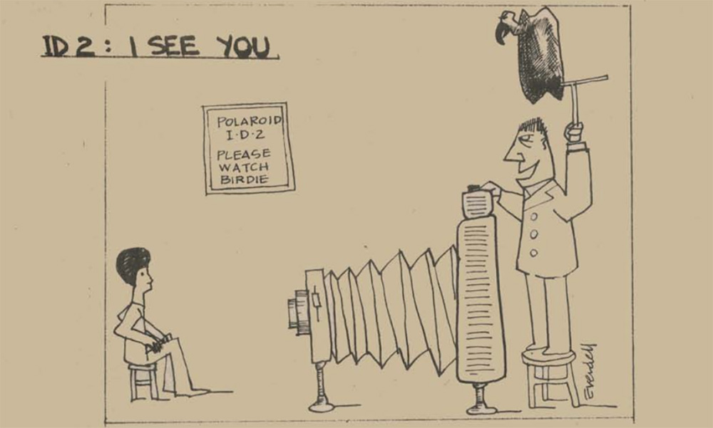 A cartoon sketch of a gigantic Polaroid camera with a photographer holding a “birdie” over his head.